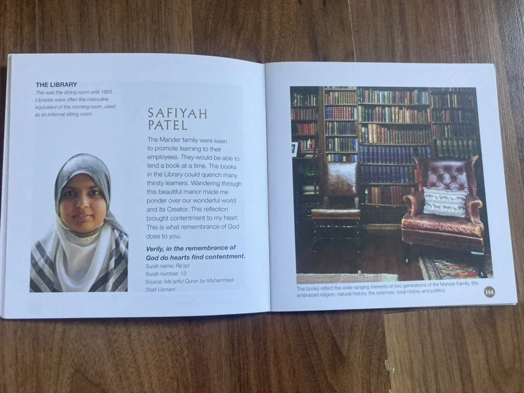 Interior spread headed ‘THE LIBRARY’, with a contributor’s reflection on remembrance and a Qur’anic verse from Surah Ra’ad — ‘Verily, in the remembrance of God do hearts find contentment’ — set facing a photograph of the Manor’s leather-armchaired library with floor-to-ceiling shelves.